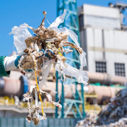 Close,Up,Of,Man,Holding,Shredded,Municipal,Waste,In,Front